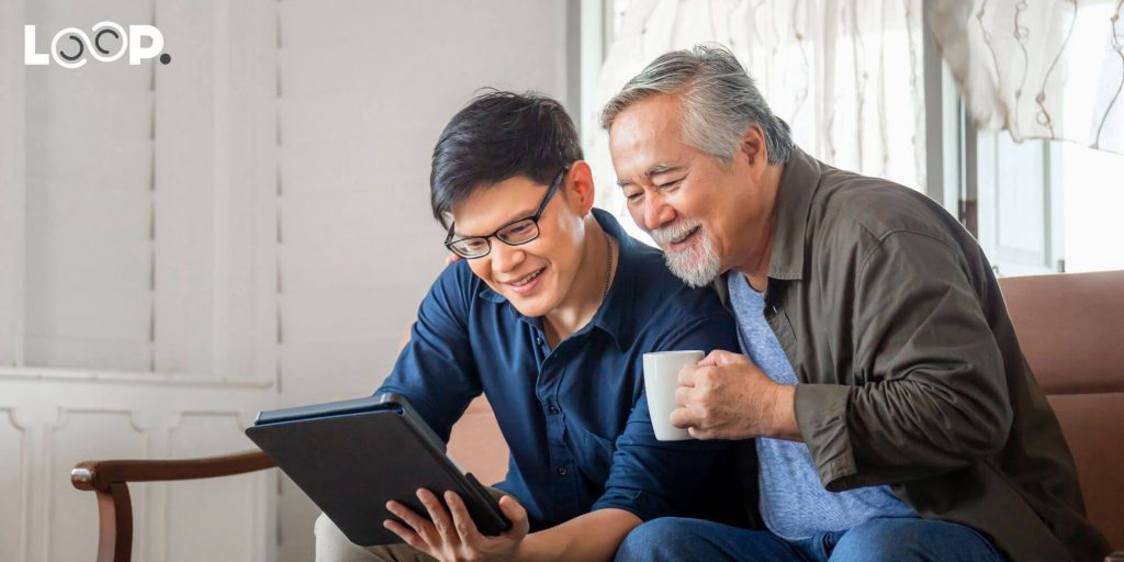 2 people looking at an interactive website on a tablet