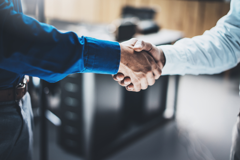 Business partnership handshake concept.