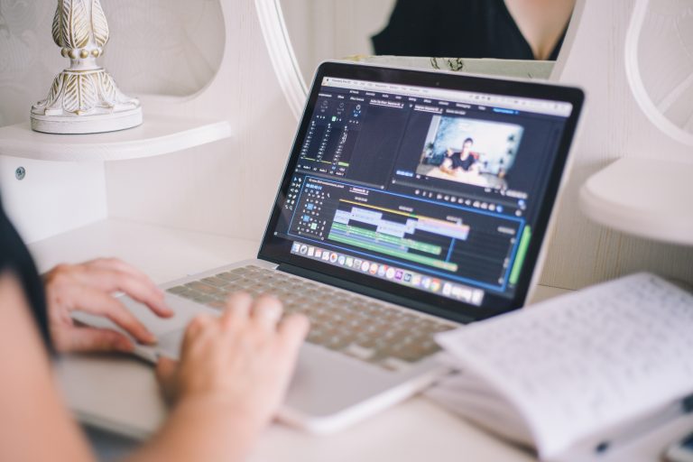 lady editing video on laptop