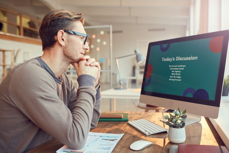 man watching webinar on computer