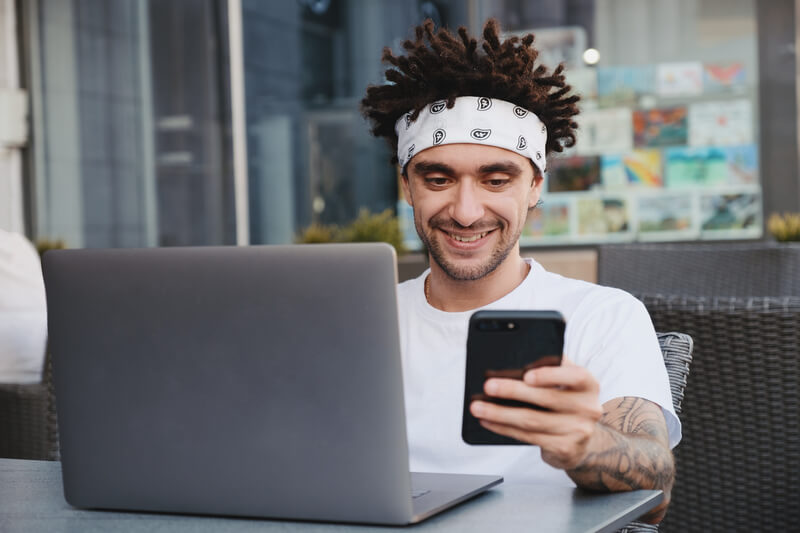 Happy guy holding smartphone