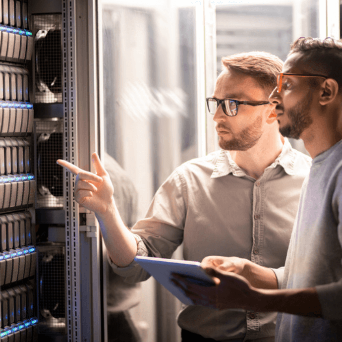 two men looking at server stack