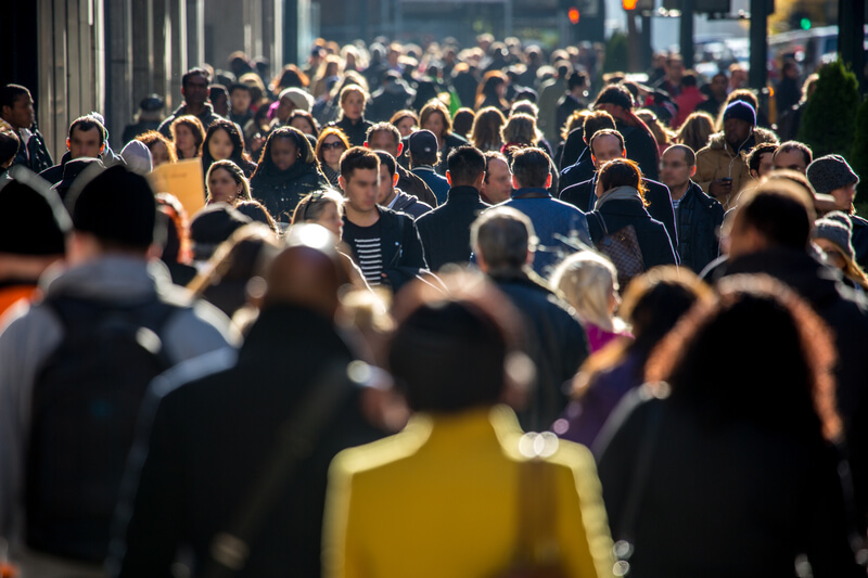 Crowd of people walking on city street