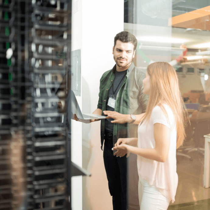 Colleagues discussing in office server room