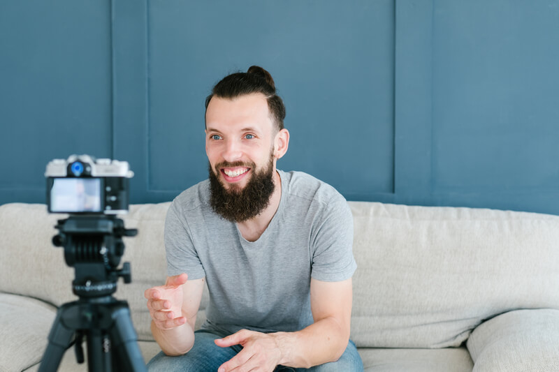 Social media influencer smiling man shoot video