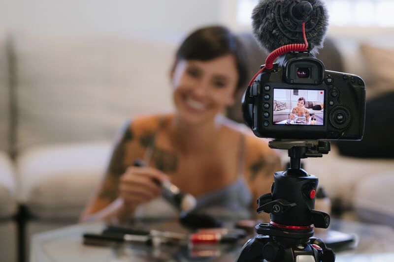 young lady selling cosmetics via video camera