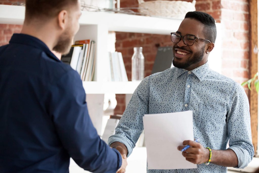 Executive manager greeting company client starting business meeting