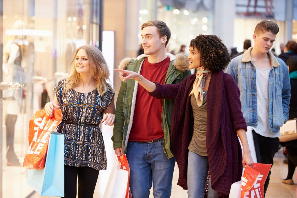 Group Of Young Friends Shopping In Mall Together