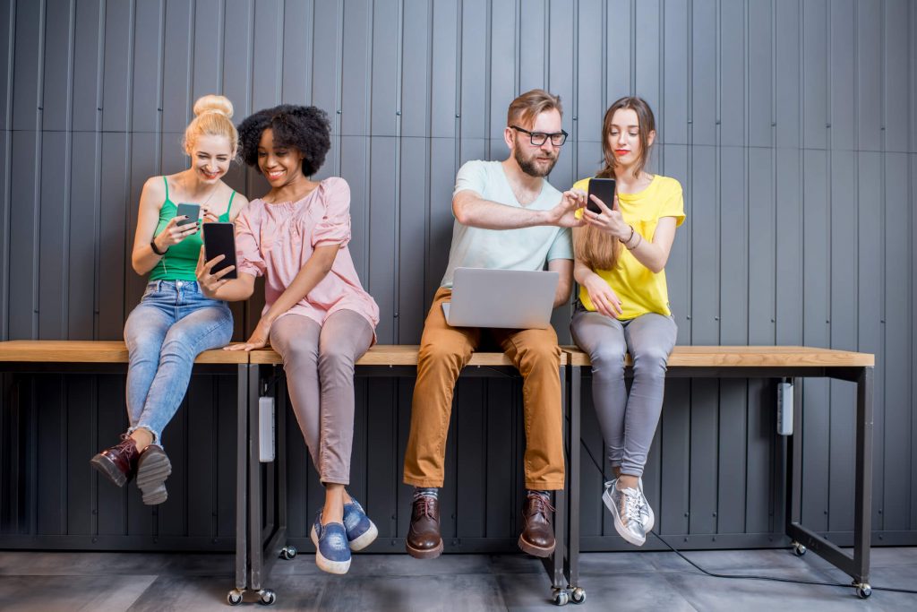 Group of young people with gadgets indoors