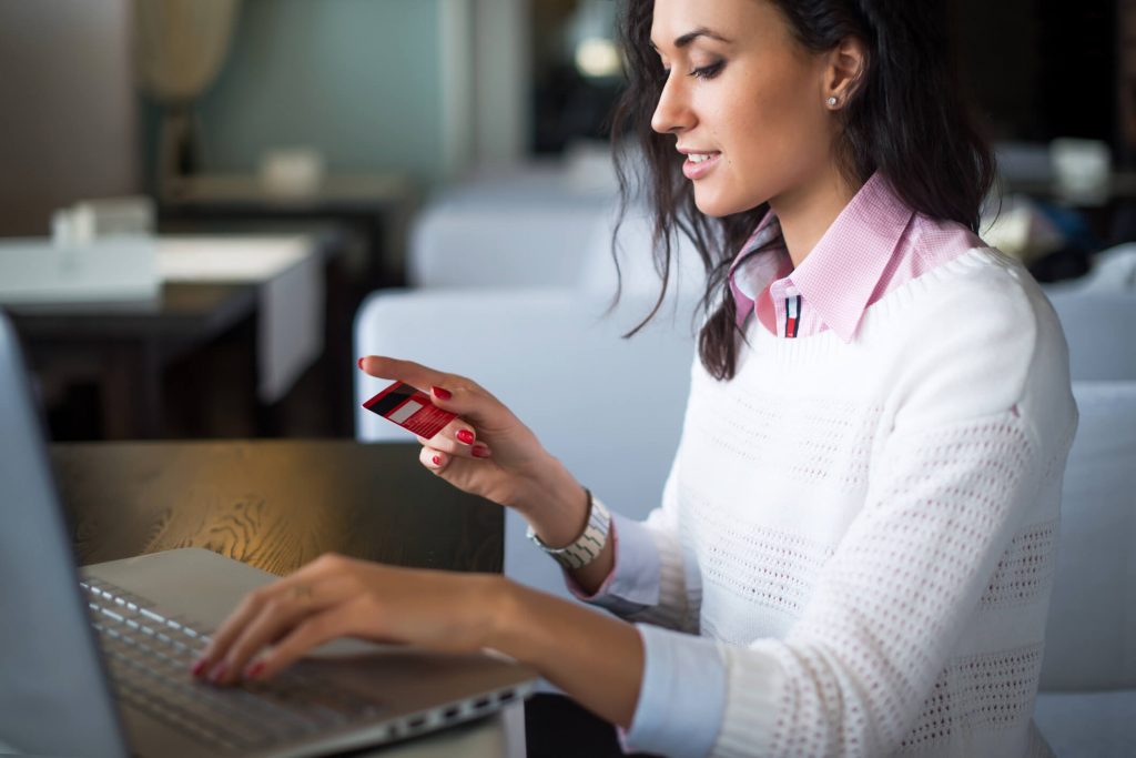 Woman doing online shopping at cafe, 