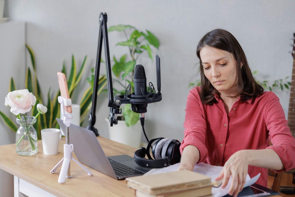 woman in a home office records podcast audio content