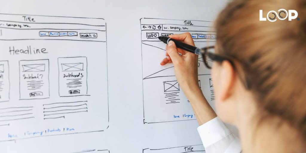 a person drawing out a website wireframe