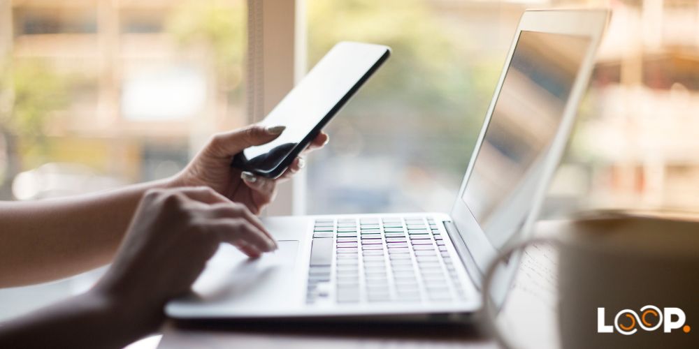 Woman on phone looking at computer