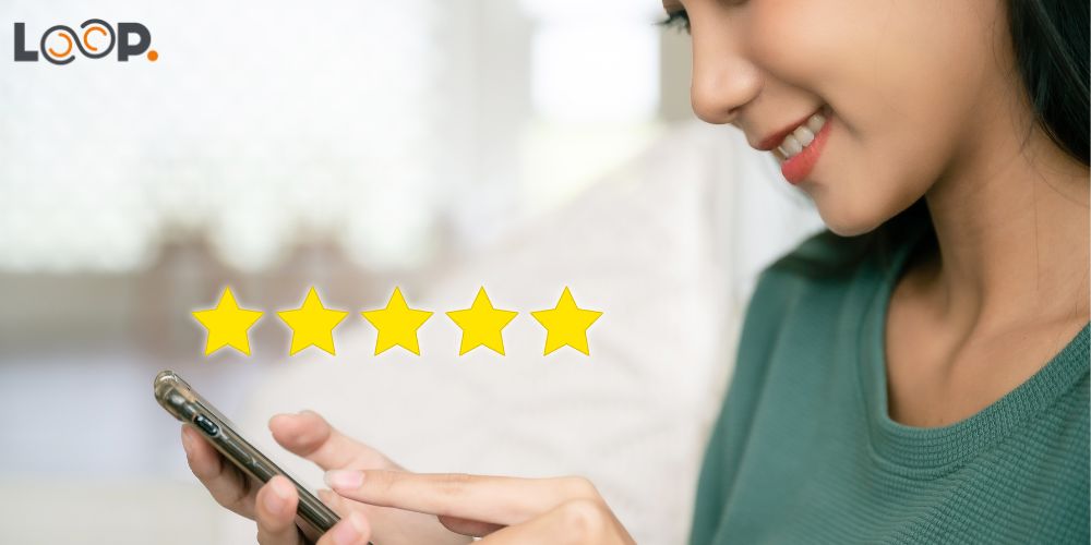 Young woman looking at phone with 5 stars