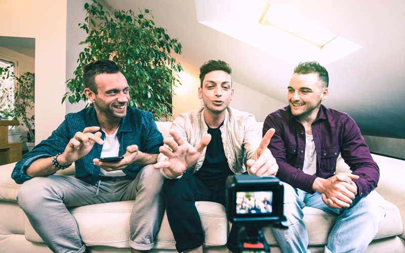 Group of men talking front of a camera