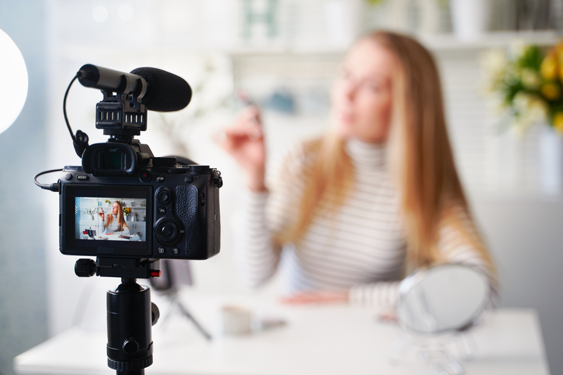 Blurred lady infront of camera recording.