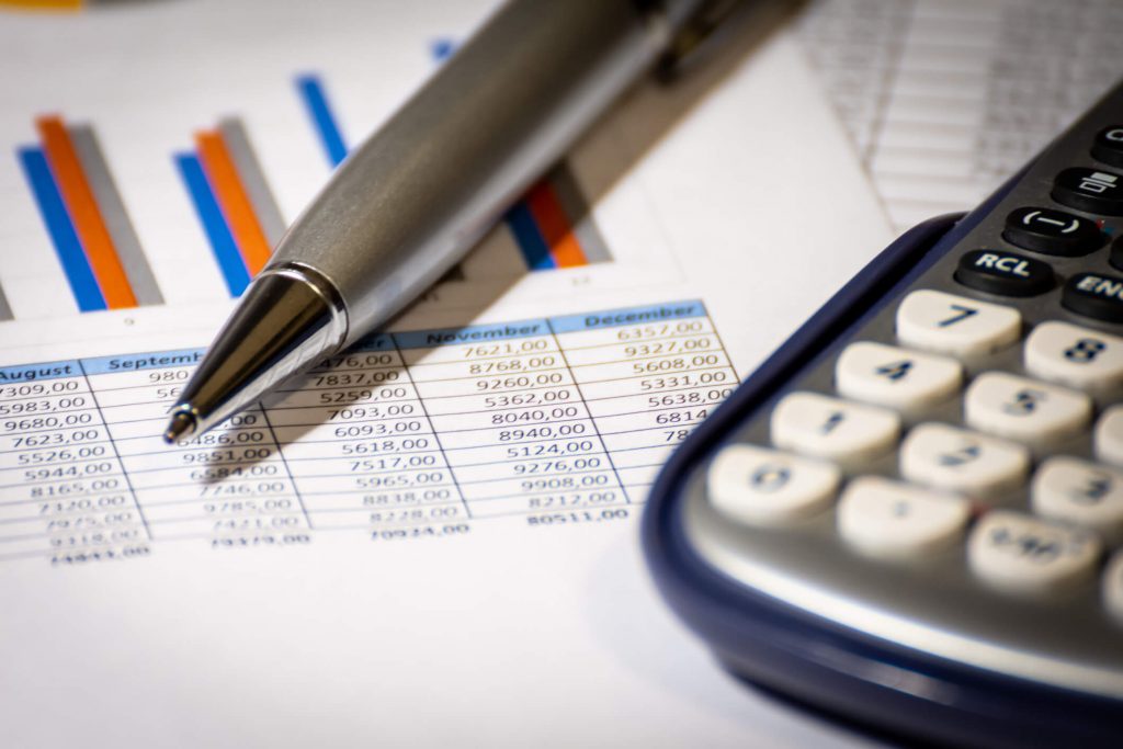 Close up of pen, calculator and paper