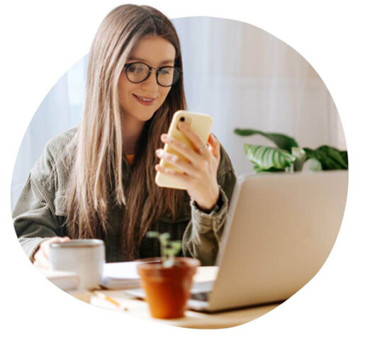 Person on a phone in front of laptop - Loop Digital